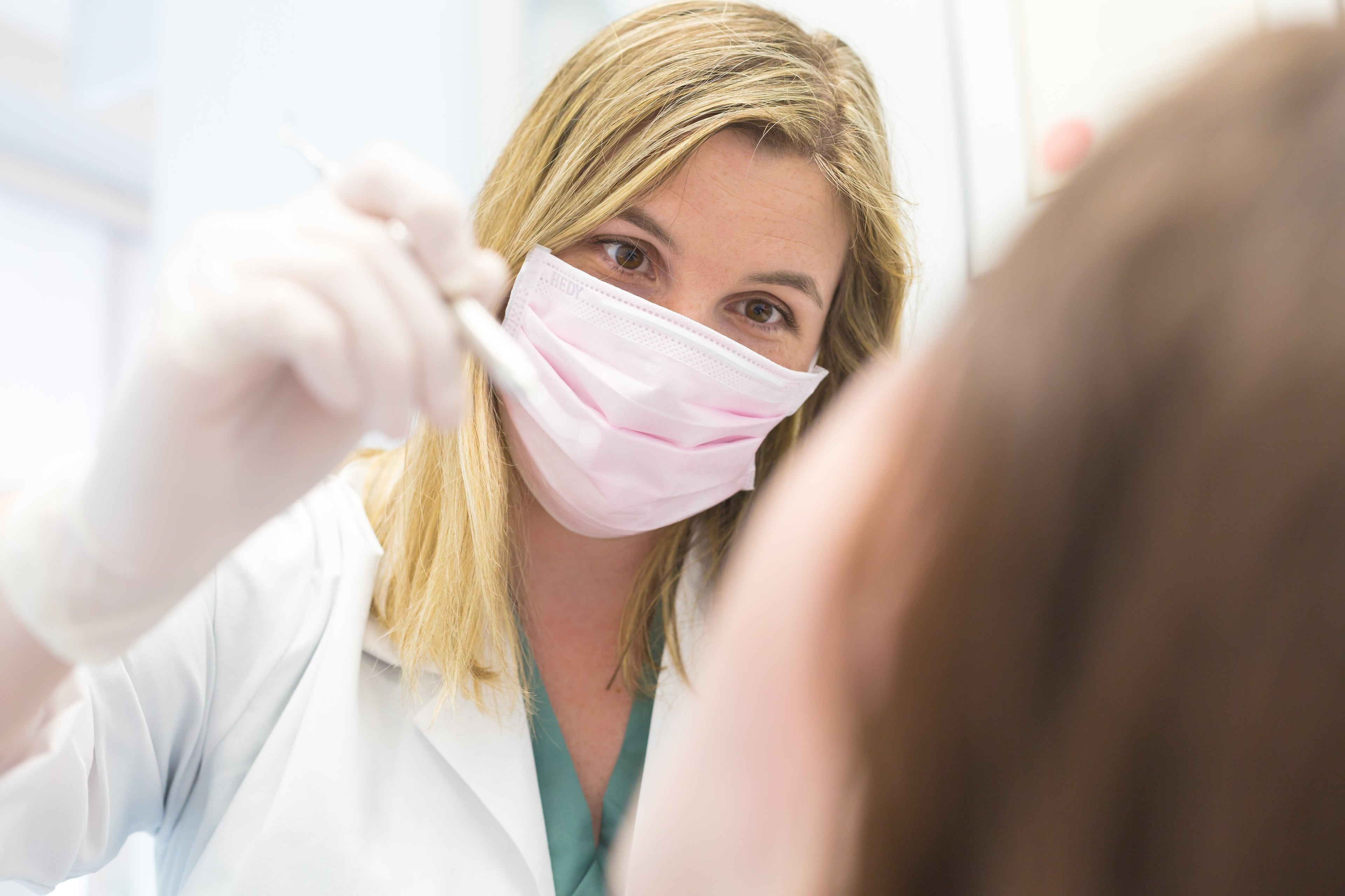 Dentist looking at patient