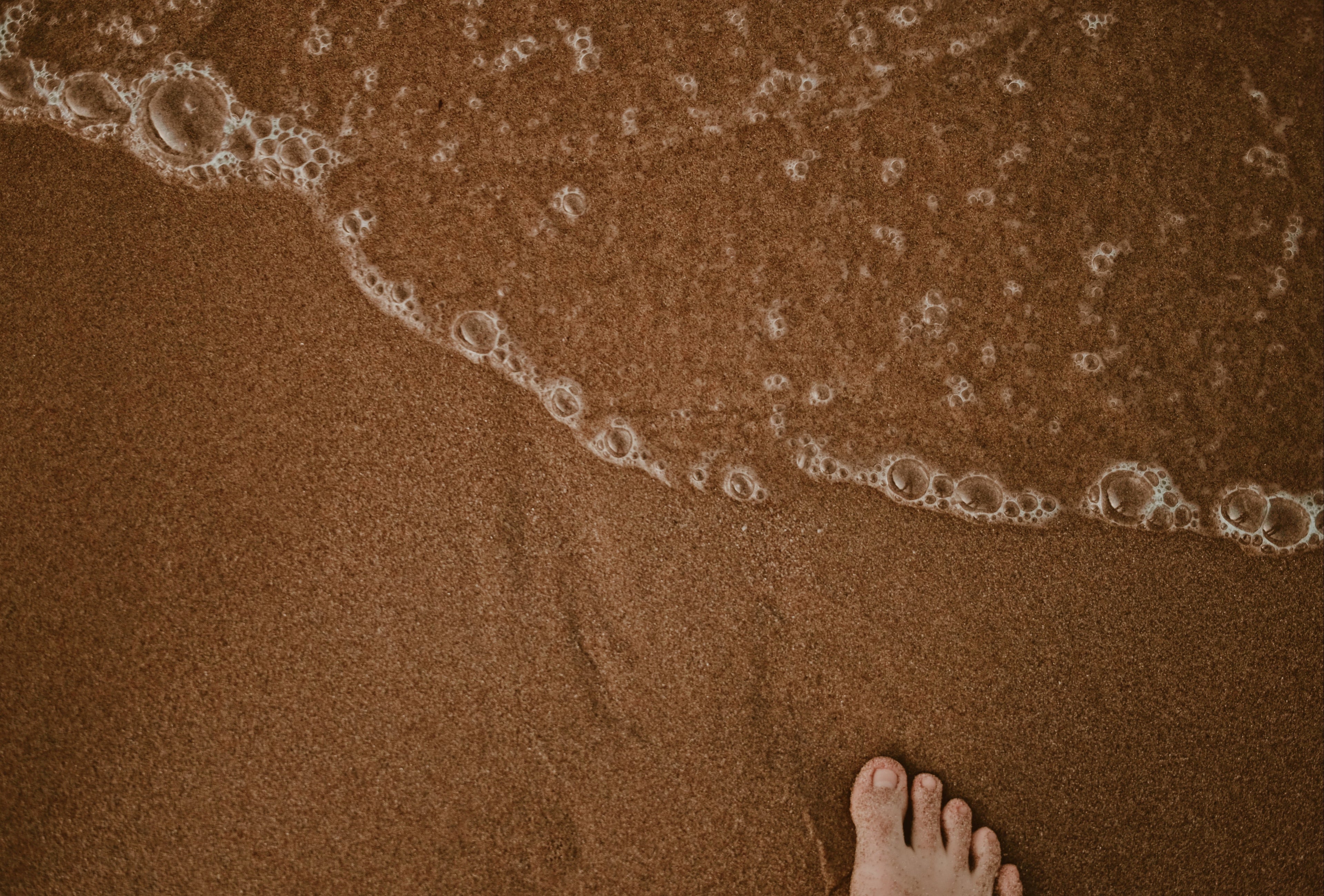 feet on a sandy beach